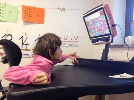 Isabel uses the Tobii eye tracking communicator