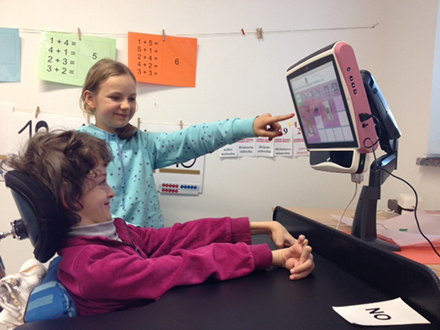 Isabel uses the Tobii eye tracking communicator