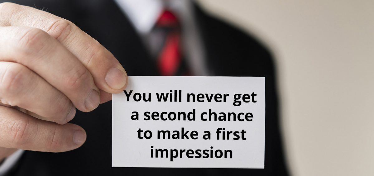 man holding businesscard first impression