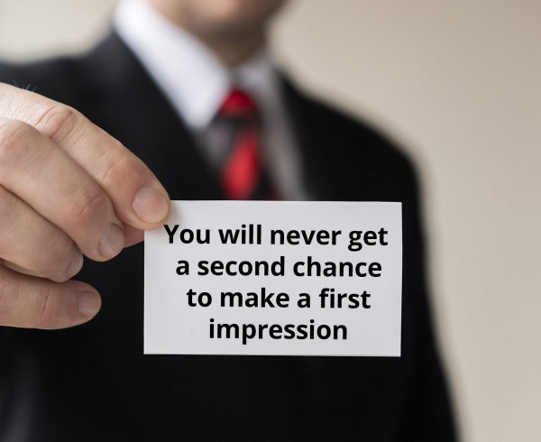 man holding businesscard first impression