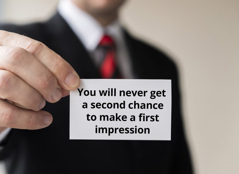 man holding businesscard first impression